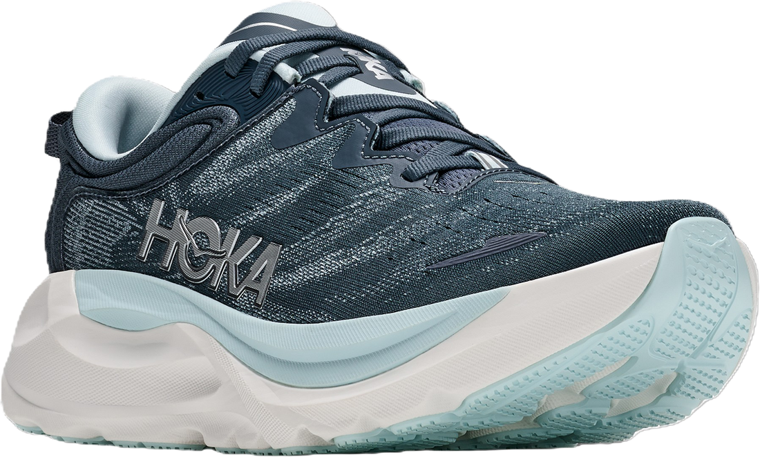 A Hoka running shoe in dark navy blue with a textured knit upper, a thick white midsole, and light blue accents on the collar and outsole.