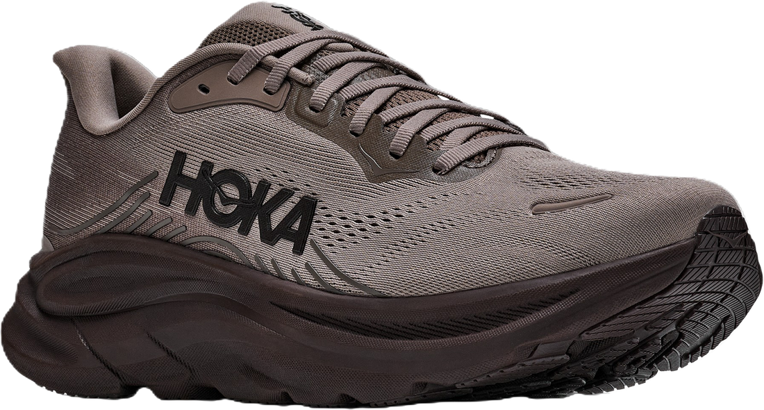 A Hoka running shoe in a muted taupe-gray and dark brown colorway, featuring a thick cushioned sole and the HOKA logo on the side, set against a plain white background.
