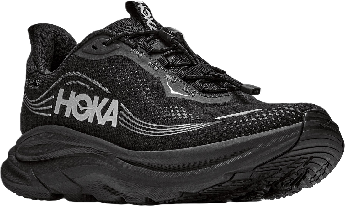 A black Hoka trail running shoe with a thick black midsole and white HOKA branding on the side, shown against a plain white background.
