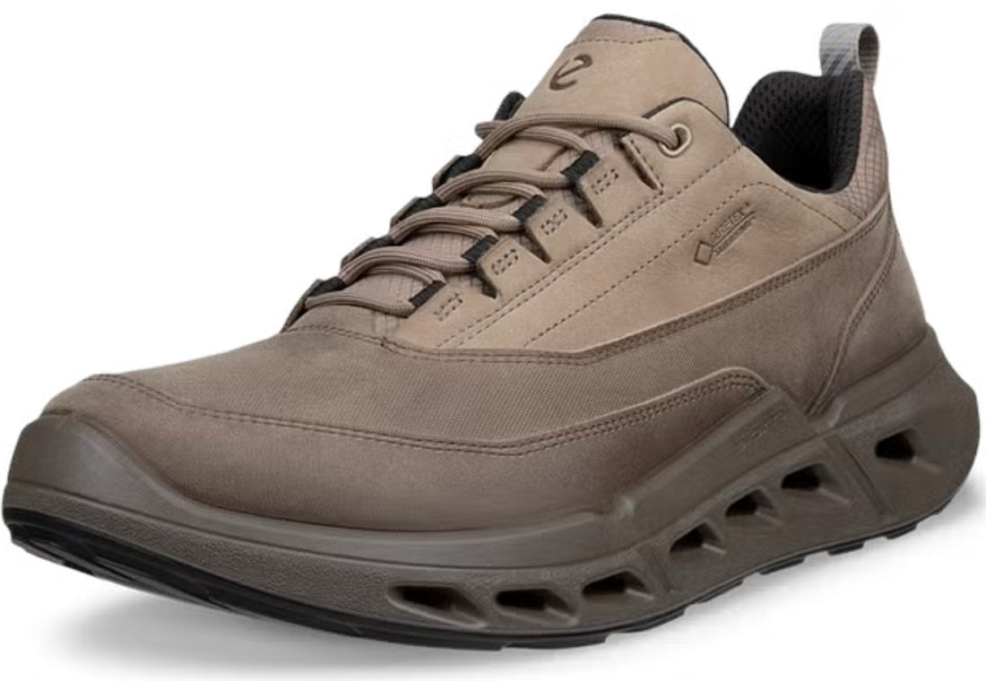 A single brownish-gray waterproof sneaker with a chunky, cushioned sole and black laces, shown from a three-quarters angle on a white background.